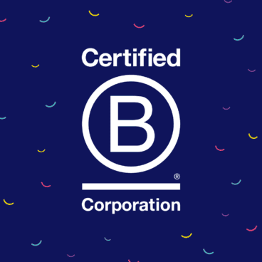 A navy blue square with colorful smile-shaped confetti in the background. The center contains a logo that says certified b corporation. The image conveys a sense of celebration.